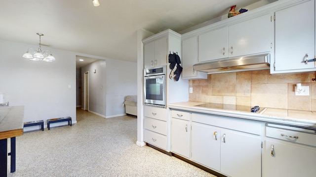 kitchen featuring stainless steel oven, hanging light fixtures, black electric stovetop, decorative backsplash, and white cabinets