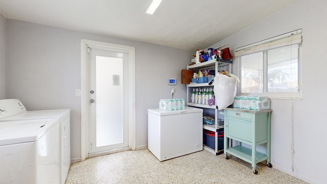 clothes washing area with independent washer and dryer and a healthy amount of sunlight