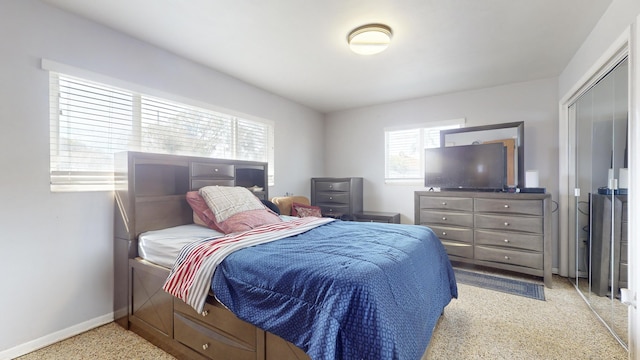bedroom with baseboards and light colored carpet