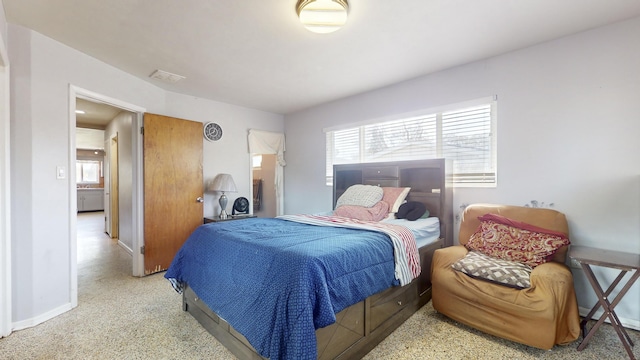 bedroom with baseboards and multiple windows