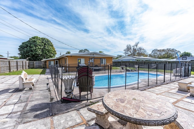 view of swimming pool with a patio area, a fenced in pool, and a fenced backyard