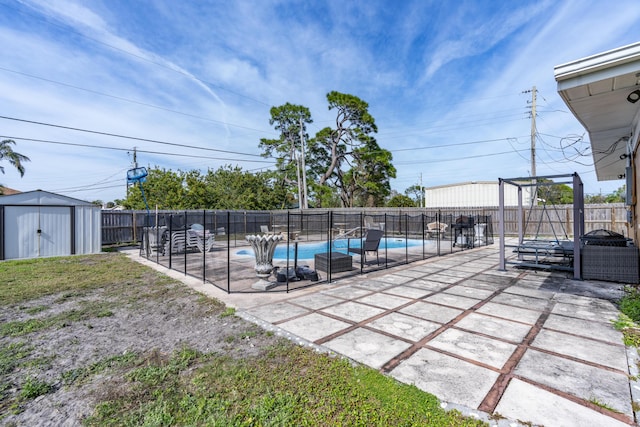 view of swimming pool featuring a patio and a storage unit