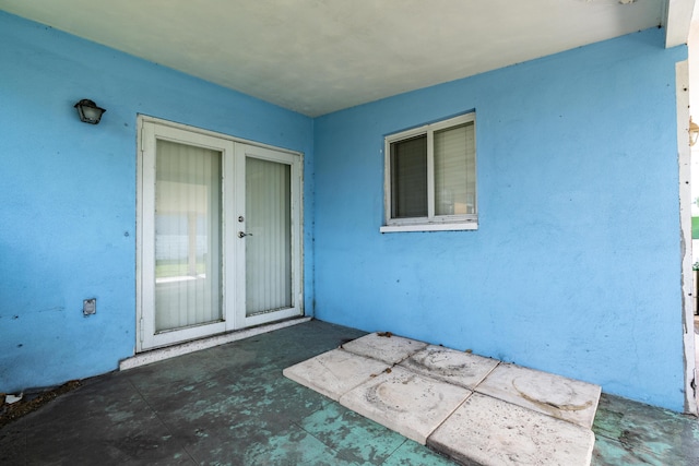 property entrance featuring a patio area and stucco siding