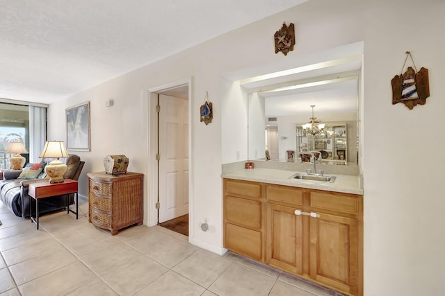 bathroom featuring vanity, tile patterned floors, and a chandelier