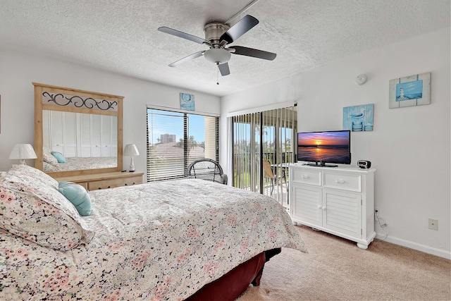 carpeted bedroom featuring access to exterior, a textured ceiling, and ceiling fan