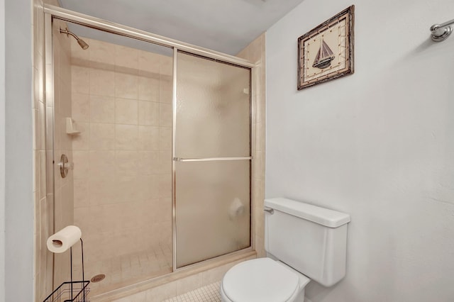 bathroom with toilet and an enclosed shower