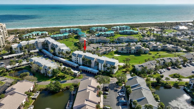 birds eye view of property with a water view and a beach view