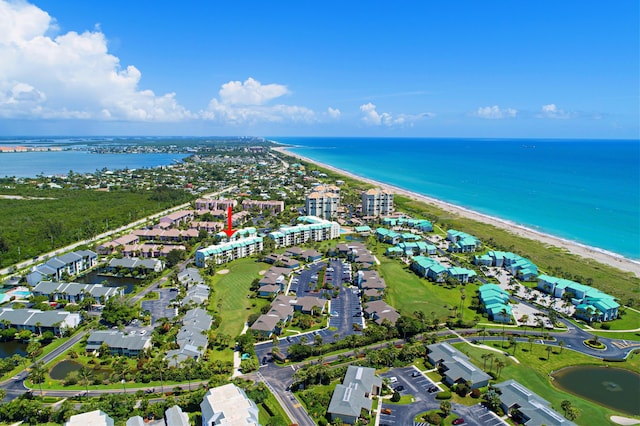 drone / aerial view with a water view and a view of the beach