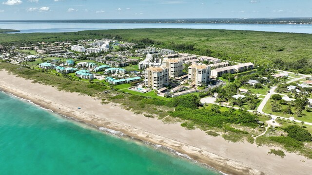 drone / aerial view featuring a beach view and a water view