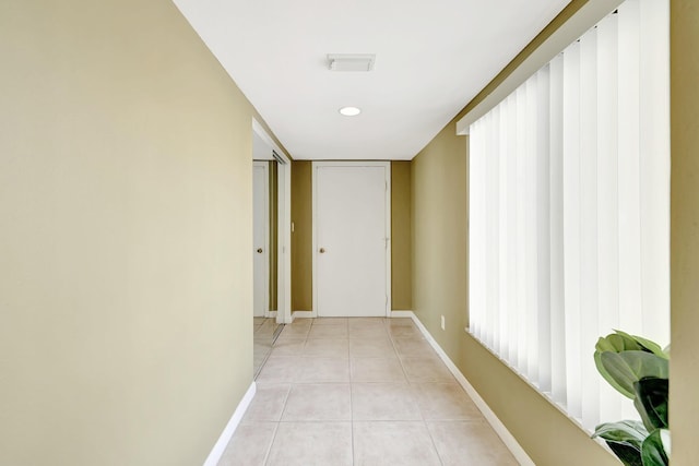 hall with light tile patterned floors