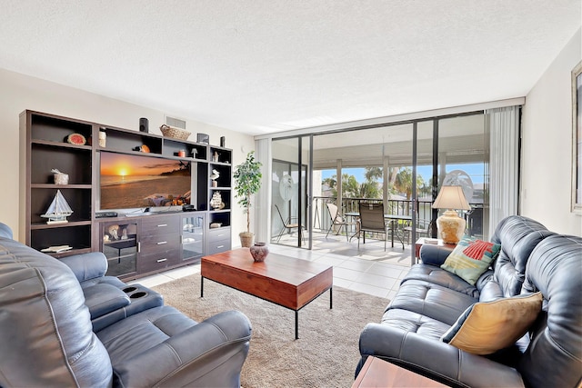 living room with a wall of windows, a textured ceiling, and light tile patterned flooring