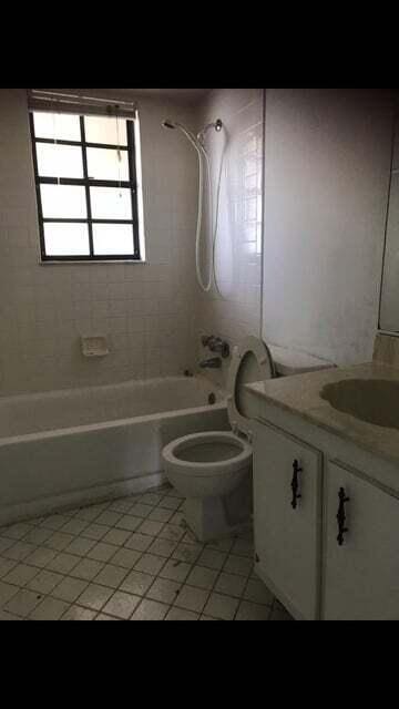 full bathroom featuring tiled shower / bath, vanity, toilet, and tile patterned flooring