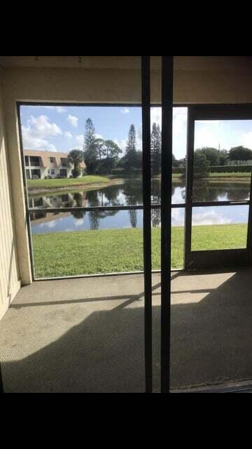 doorway featuring plenty of natural light and a water view