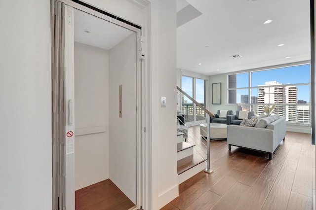 living room with hardwood / wood-style flooring and elevator