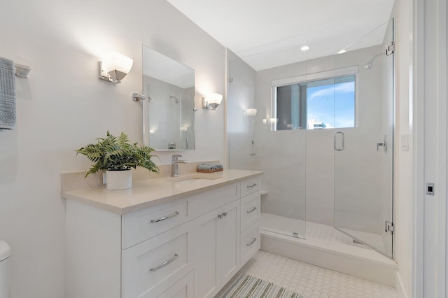 bathroom featuring vanity and a shower with door