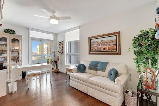 living room with ceiling fan and dark hardwood / wood-style floors