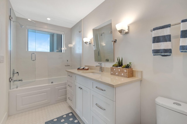 full bathroom with vanity, toilet, and bath / shower combo with glass door