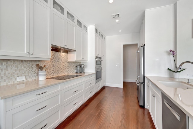 kitchen featuring light stone countertops, appliances with stainless steel finishes, sink, and white cabinets