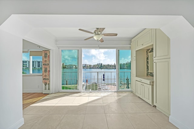 interior space featuring ceiling fan and a water view