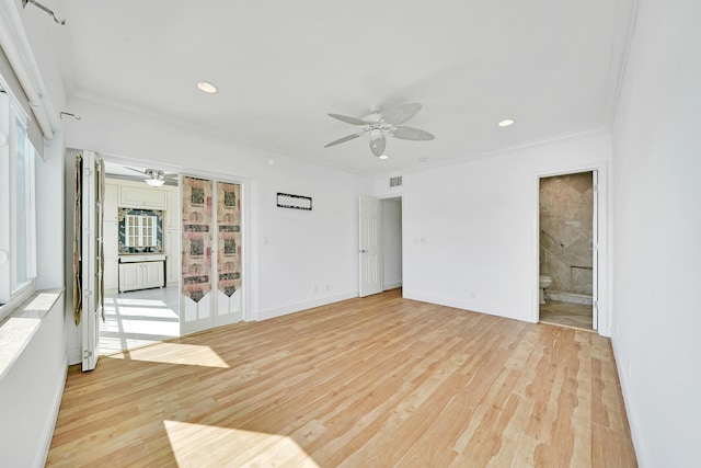 unfurnished room featuring crown molding, ceiling fan, visible vents, and light wood-style floors