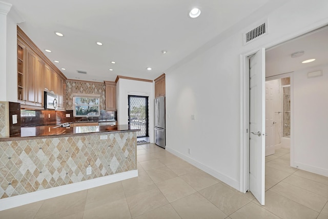 kitchen with appliances with stainless steel finishes, dark countertops, visible vents, and recessed lighting