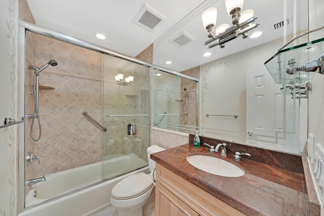 laundry area with stacked washer and dryer, laundry area, and light tile patterned flooring