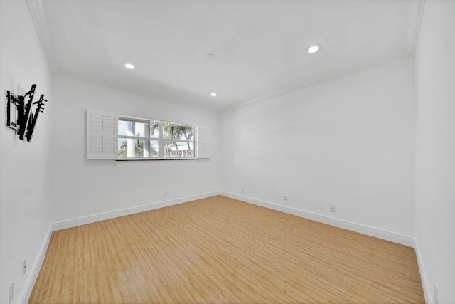 spare room featuring recessed lighting, light wood-style flooring, and baseboards