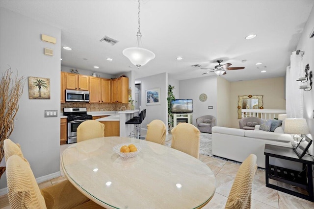 dining area featuring light tile patterned floors and ceiling fan