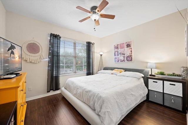 bedroom with dark hardwood / wood-style floors and ceiling fan