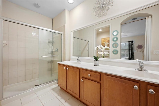 bathroom featuring vanity, tile patterned flooring, and a shower with door