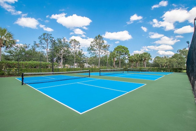 view of tennis court with basketball hoop