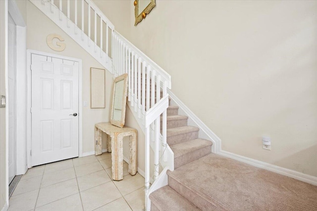 stairs featuring tile patterned floors