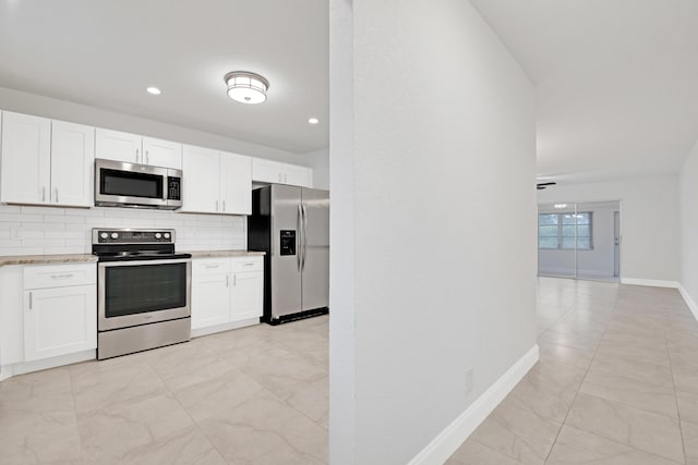 kitchen featuring white cabinetry, backsplash, and stainless steel appliances