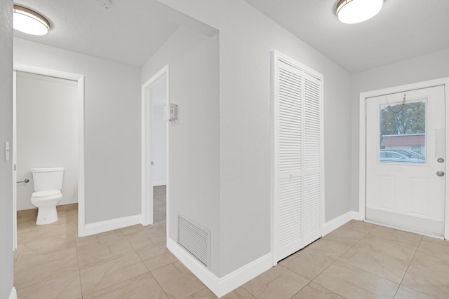 foyer with a textured ceiling