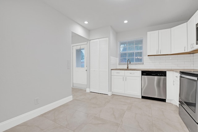 kitchen featuring sink, decorative backsplash, white cabinets, and appliances with stainless steel finishes