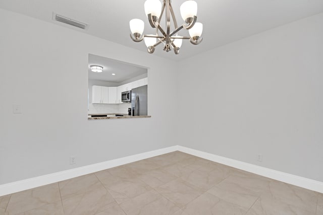 unfurnished dining area with a notable chandelier