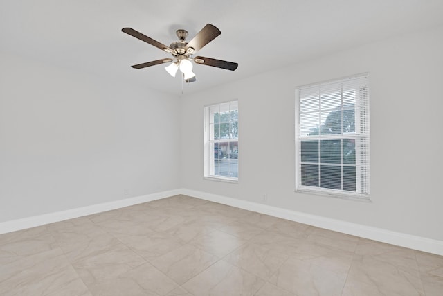 empty room with plenty of natural light and ceiling fan