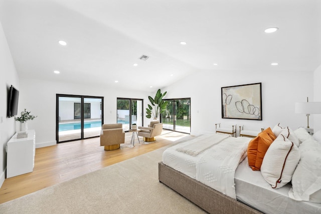 bedroom featuring vaulted ceiling, access to exterior, and light hardwood / wood-style floors