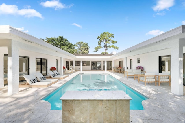 view of pool with an outdoor living space and a patio