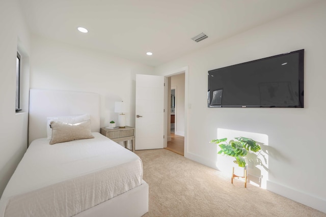 bedroom featuring light colored carpet