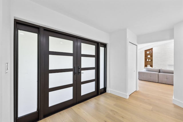 foyer entrance with french doors and light wood-type flooring