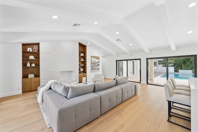 living room featuring built in features, lofted ceiling with beams, and light wood-type flooring