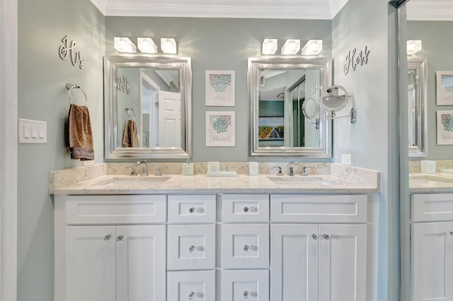 bathroom with crown molding and vanity