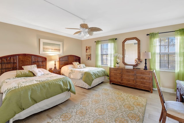 bedroom featuring crown molding, ceiling fan, and light hardwood / wood-style flooring