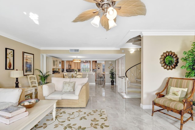 living room featuring crown molding and ceiling fan