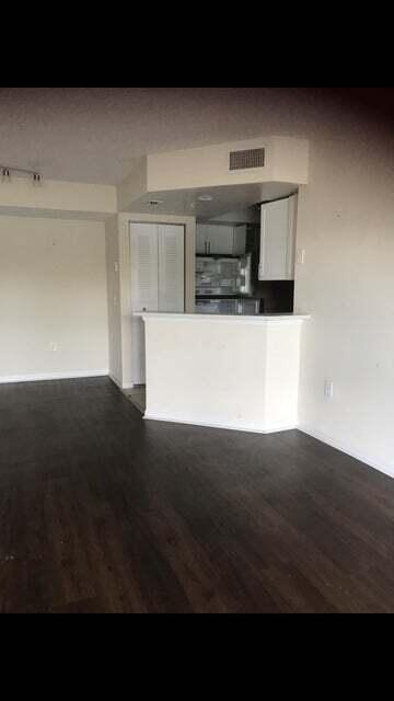 kitchen featuring dark hardwood / wood-style flooring, kitchen peninsula, and white cabinets