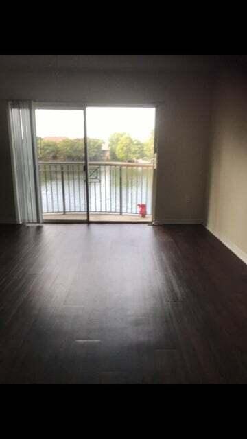 empty room featuring a water view and a wealth of natural light