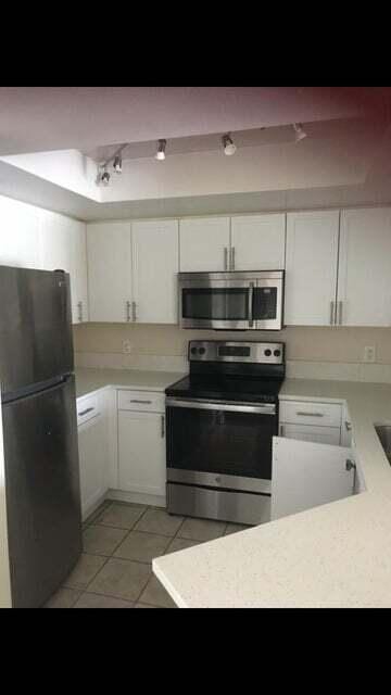 kitchen featuring white cabinetry, appliances with stainless steel finishes, and light tile patterned flooring