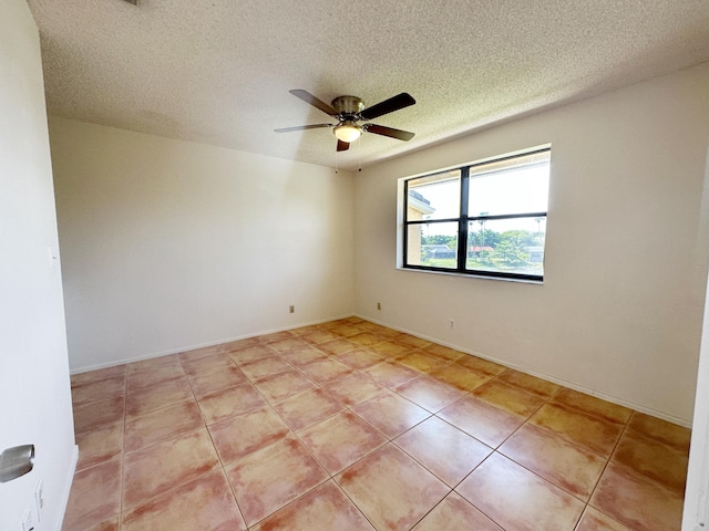 tiled spare room with ceiling fan and a textured ceiling