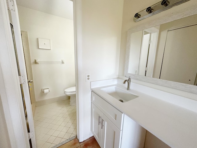 bathroom featuring vanity, toilet, and tile patterned flooring